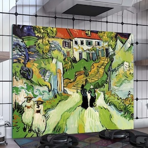 May include: A colorful kitchen backsplash with a painting of a green landscape with a white house and two figures walking on a path. The backsplash is installed above a black gas stove with four burners.