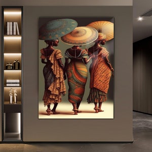 May include: Three women in colourful dresses and head wraps walk together, each holding a large, patterned umbrella. The umbrellas are shades of green, yellow, and orange.