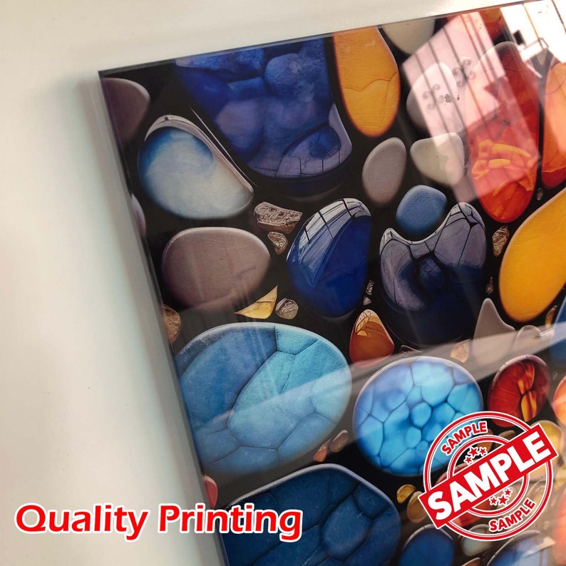May include: A close-up of a colorful abstract art print featuring a mosaic of blue, orange, and red stones. The print has a glossy finish and a "SAMPLE" stamp in the lower right corner.