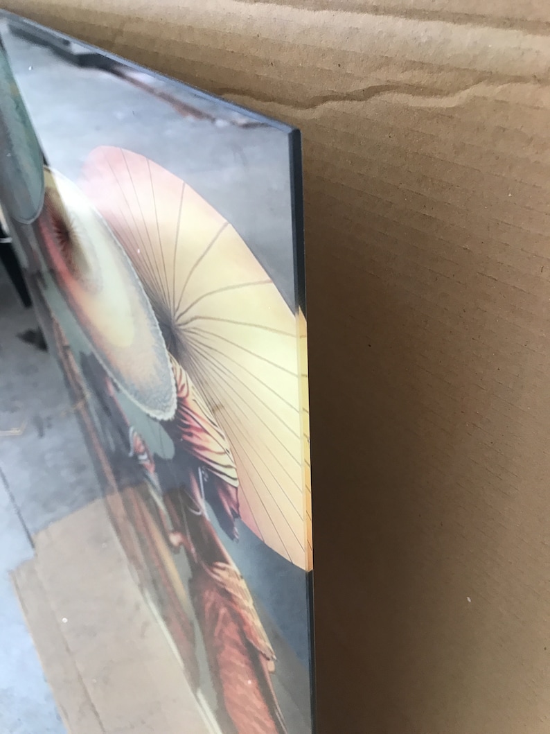 May include: A close-up of a colourful painting featuring two women wearing traditional Japanese clothing and holding parasols. The painting is framed and has a glossy finish.
