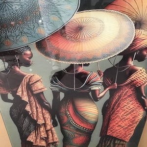 May include: Three women wearing colourful patterned dresses and head wraps stand under large, patterned umbrellas. The umbrellas are a teal blue, a light orange with a white lace trim, and a red and orange umbrella.