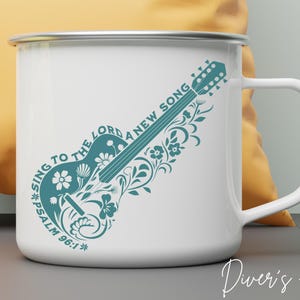 May include: White enamel mug with a teal blue design of a guitar with floral accents. The text "Sing to the Lord a new song, *Psalm 96:1*" is printed on the mug.