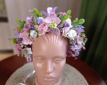 Modern wreath on the head whith violet flowers.Flower crown for the holiday. Unique сrown for the bride.