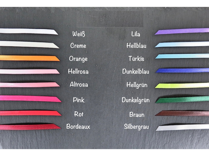 May include: A chart showing different colors of ribbon with the German names for each color written next to them. The colors are white, cream, orange, light pink, pink, red, burgundy, lilac, light blue, turquoise, dark blue, light green, dark green, brown, and silver gray.