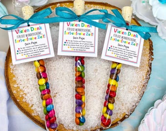 May include: Three small glass tubes filled with colorful candy. Each tube has a small tag attached with the text "Vielen Dank für die wunderschöne, farbenfrohe Zeit!" and "Dein Pepe".