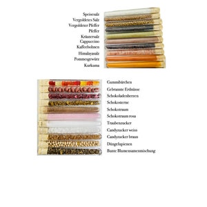 May include: Two rows of clear glass test tubes filled with various spices, candies, and other ingredients. The top row includes spices like Himalayan salt, turmeric, and pepper. The bottom row includes candies like gummy bears, chocolate hearts, and candy sprinkles.