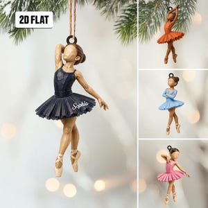 May include: A hanging ornament featuring a ballerina figurine with a carved wood texture. The main figure wears a dark blue tutu with the name Sophia printed on it. Additional smaller images show ballerinas in orange, light blue, and pink tutus.