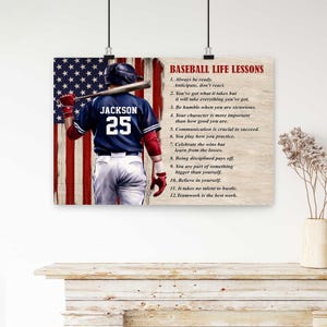 May include: A rectangular wall poster featuring a baseball player in a dark blue jersey with the name JACKSON and number 25, holding a bat against a US flag background. The text BASEBALL LIFE LESSONS and twelve numbered points are printed on the right.