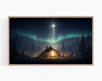 May include: Framed print of a winter night scene. A bright star shines over a small wooden structure with figures inside. The night sky features the aurora borealis and a starry background. The artwork is set in a wooden frame.