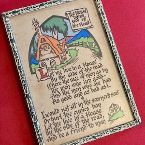 May include: A rectangular framed print featuring a cottage illustration and the poem The House by the Side of the Road. The artwork includes a house with an orange roof, green trees, and blue hills. The black frame has a distressed white finish.