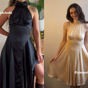 May include: Two satin dresses are shown, one black and one champagne. Both have a halter neckline and flared skirt. The black dress features a thigh-high slit. The dresses are examples of formal wear.