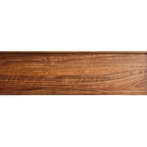 May include: A rectangular wooden tray with a smooth, polished finish and visible natural grain patterns. The tray features slightly raised edges and rounded corners, showcasing a rich, warm brown color throughout the entire surface area.