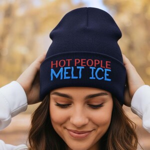 May include: Navy blue beanie with the text "HOT PEOPLE MELT ICE" in red and blue. The beanie is made of a soft, knitted material and is a winter accessory.