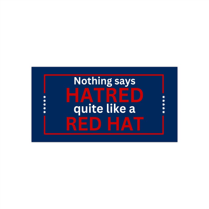 May include: A blue and white sign with the text "Nothing says HATRED quite like a RED HAT" in red and white letters.