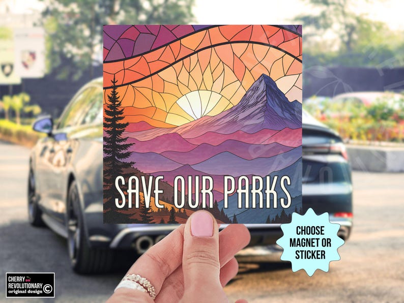 May include: A colorful stained glass style illustration of a mountain range with a sunset in the background. The text "Save Our Parks" is printed in white on a black banner at the bottom of the image. The image is available as a magnet or sticker.