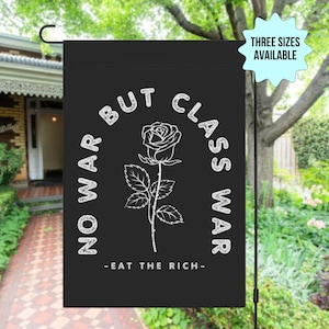May include: Black garden flag with white text that reads "No War But Class War - Eat The Rich -" with a white rose graphic.