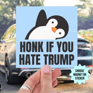 May include: A blue and white car magnet with a cartoon penguin and the text "Honk if you hate Trump". Choose magnet or sticker.