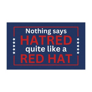 May include: A blue doormat with white stars and a red border. The text on the doormat reads "Nothing says HATRED quite like a RED HAT."