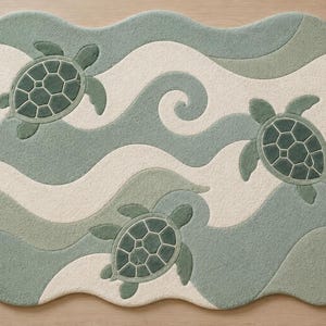 May include: A sea turtle-themed rug with a wavy design in shades of green and cream. Three sea turtles are featured on the rug. The rug is shaped like a large irregular oval.