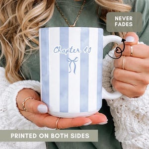 May include: White ceramic mug with blue vertical stripes and the text "Chapter 40" in a script font. A blue bow graphic is below the text. The mug is printed on both sides and has a white handle.