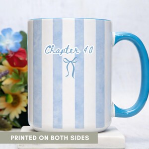 May include: A white ceramic mug with blue vertical stripes and a blue handle. The mug has the text "Chapter 40" with a bow graphic. The words "PRINTED ON BOTH SIDES" are at the bottom of the mug.