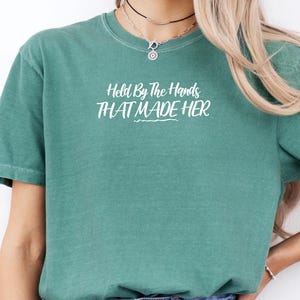 Held By The Hands That Made Her Shirt, God Created, Christian Merch, Held By God, Christian Graphic Ts, Love, Gift For Her, Jesus Healing