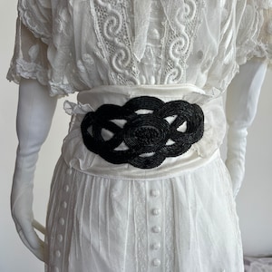 Women's belt with large antique detail. . black bead embroidery 1900. fabric white taffeta length 68 width 12. cm