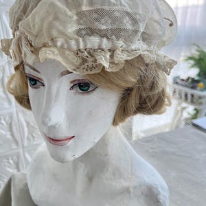 Antique night cap. 1900. Europe. Round cap with 2 rows of lace along the edge. Embroidery with beige threads in front. There is a bow. Antiq