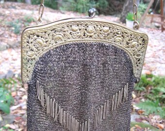 Antique purse from the 1920's. USA. The purse is quite unique in that it has a row of fringe down the middle of the purse, and along the bot