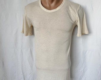May include: A plain, off-white t-shirt with short sleeves and a crew neck.