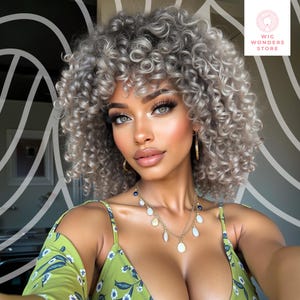 May include: A woman with light skin and gray curly hair is wearing a green floral top and gold jewelry. The image is from Wig Wonders Store.