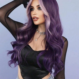 May include: A woman with long, wavy purple hair with a light blonde face-framing highlight. She is wearing a black satin top, a sheer black long-sleeved shirt, and blue jeans. A silver necklace with a pendant is around her neck.