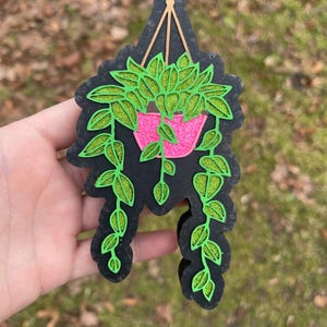 May include: A white ceramic mug with a black handle and the text "But First, Coffee" in a black, bold font. The mug is on a white surface.