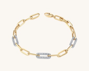 May include: A gold chain bracelet with rectangular links, each set with small diamonds.