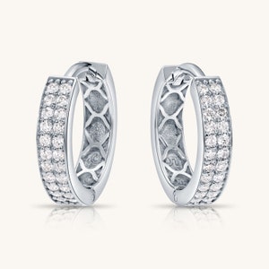 May include: A pair of silver hoop earrings with a double row of clear cubic zirconia stones.
