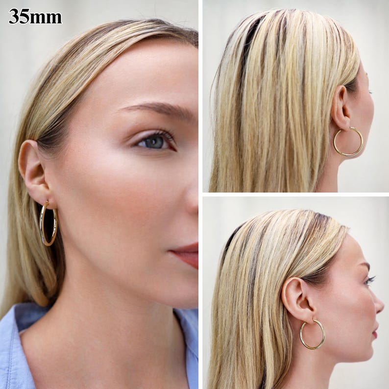 May include: A pair of gold hoop earrings with a smooth, polished finish. The circular earrings have a diameter of 35mm. The design features a simple, continuous hoop structure that secures through the earlobe with a thin, integrated post.
