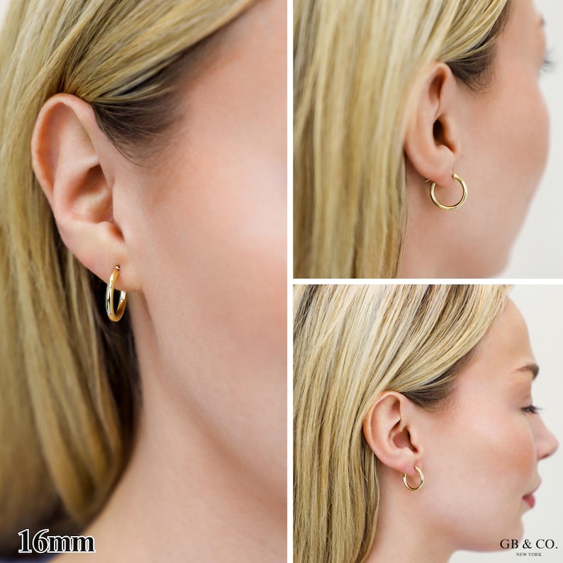 May include: A pair of gold hoop earrings with a smooth, polished finish. The earrings are circular in shape and feature a 16mm diameter as indicated by the text. The design is simple and classic, consisting of a thin, continuous metal band.