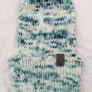 Reversible white, green, and blue handknit hat made with hand-dyed superwash wool yarn from A Yarn to Dye For