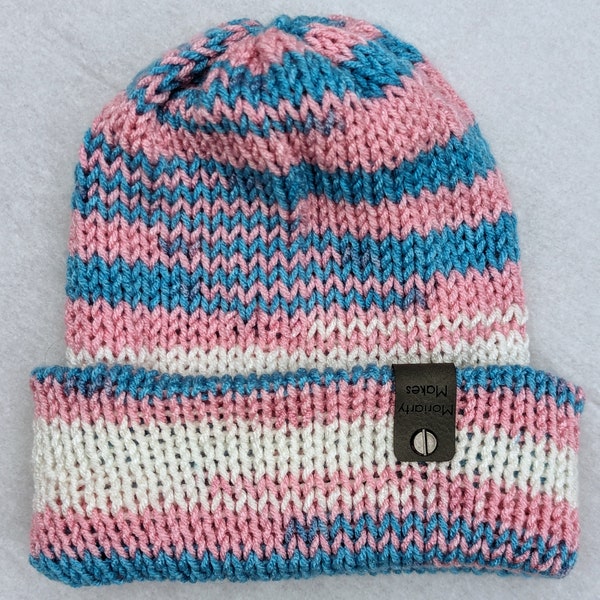 Reversible handknit teen/adult hat in transgender flag colors (pink, blue, and white)