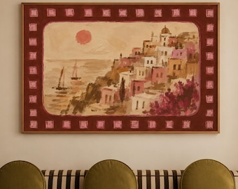 May include: A rectangular framed painting depicting a coastal village with white and pink buildings, a red sun, and sailboats on the water. The artwork features a dark red border with a repeating light pink square pattern, displayed above a striped sofa.