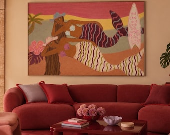 May include: A large rectangular wall art piece featuring two mermaids lounging on a beach with a surfboard that reads, You can't stop the waves but you can learn to surf. The artwork uses pink, orange, and purple tones with tropical foliage.