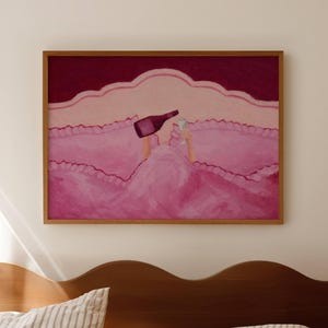 May include: A framed artwork depicts a person in a pink bed pouring wine into a glass. The painting has a pink and burgundy color palette. The artwork is displayed above a wooden headboard with striped pillows.