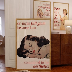 May include: Three framed vintage-style posters with text and illustrations. The largest poster reads "crying in full glam because I am committed to the aesthetic!". Other posters say "having a resting bitch face prevents wrinkles" and "Oops... did it for the plot... again."