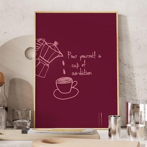 May include: A rectangular wall art print with a deep burgundy background featuring a light pink line drawing of a moka pot pouring coffee into a cup. The text "Pour yourself a cup of ambition" is written in a casual, handwritten script style.
