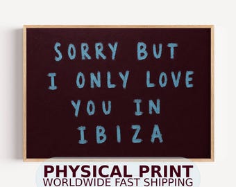 May include: A rectangular wall art print featuring a dark maroon background with the light blue painted text SORRY BUT I ONLY LOVE YOU IN IBIZA. The print is encased in a light-colored wooden frame with a clean, simple border design.