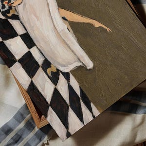 May include: An oil painting on canvas featuring a figure in a long white dress standing on a black and white checkered floor. The figure is positioned next to a solid olive green area, with visible brushstrokes and a wooden frame border.