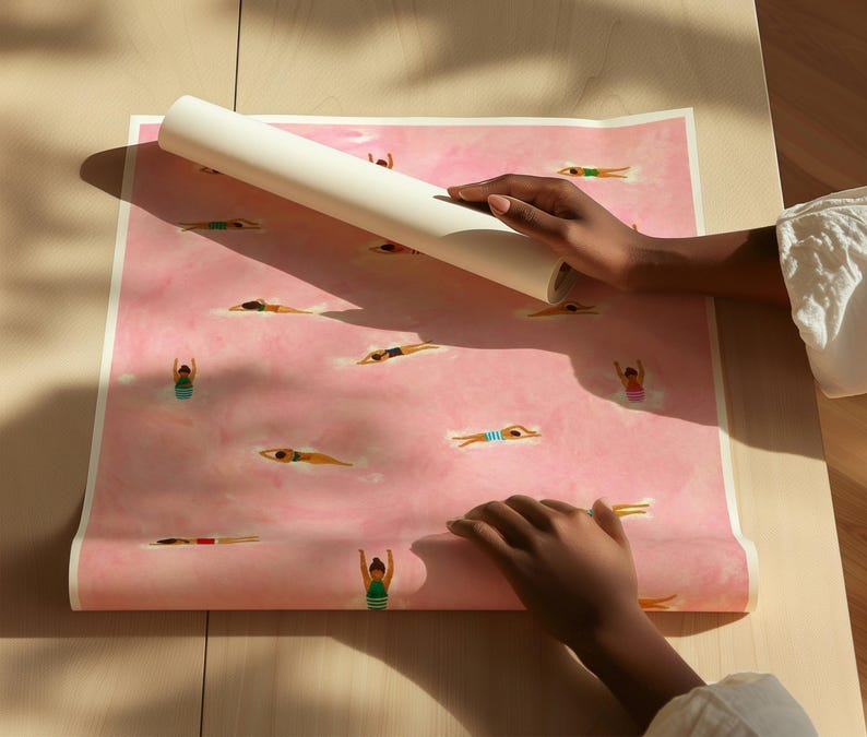 May include: A rectangular sheet of paper featuring a repeating pattern of small figures swimming in a pink, watercolor-style pool. The figures are depicted in various swimming poses, wearing colorful swimsuits against the soft pink background.