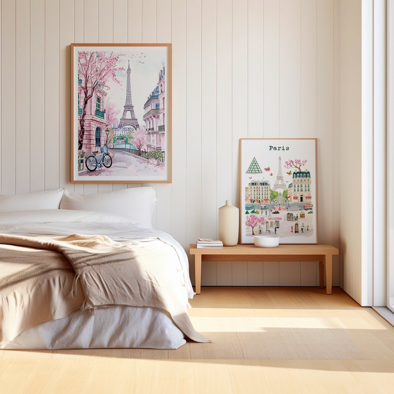 May include: Two framed illustrations of Paris, France. The first illustration is a watercolor painting of a street scene with the Eiffel Tower in the background. The second illustration is a stylized map of Paris with the Eiffel Tower in the center.