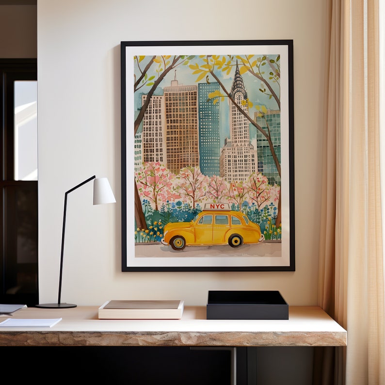 May include: A watercolor painting of a yellow taxi cab driving through Central Park in New York City. The Chrysler Building is visible in the background, and the trees are in bloom. The painting is framed in black.