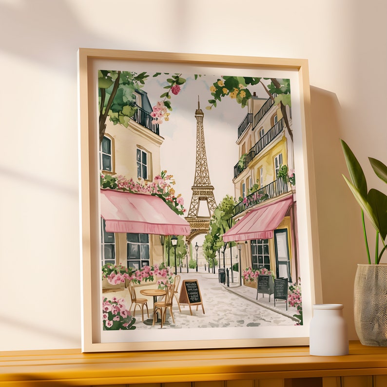 May include: A watercolor painting of a Parisian street scene with the Eiffel Tower in the background. The street is lined with pink-awninged cafes and blooming flowers.